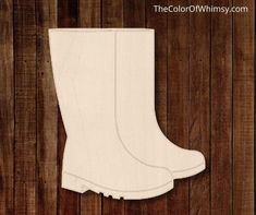 a pair of white boots sitting on top of a wooden floor