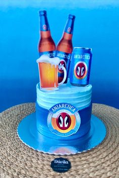 a cake made to look like two beer cans and one is sitting on top of a straw hat