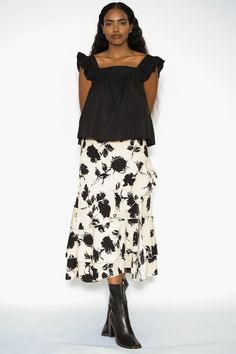 Indulge in the charm of our Cotton Beige Floral Ruffle Layer Skirt. Adorned with a sophisticated black painting floral print, this skirt exudes elegance. The thoughtful design includes an open slip on the left front, adding a playful yet graceful touch. Crafted from comfortable cotton, this dress offers a delightful combination of style and ease. Embrace the beauty of nature-inspired florals in a neutral beige palette, and let the ruffle layers dance with every step. Composition: 100% Cotton Mid Summer Evening Floral Print Skirt, Summer Evening Skirt With Floral Print, Summer Evening Floral Skirt, Chic Tiered Maxi Skirt With Floral Print, Elegant Floral Print Maxi Skirt For Brunch, Chic Floral Print Maxi Skirt, Chic Skirted Maxi Skirt With Floral Print, Long Floral Print Skirt For Evening, Floral Long Skirt For Evening