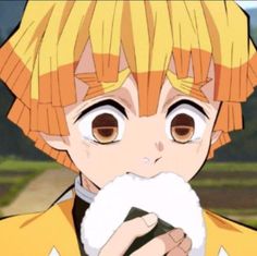 an anime character with orange hair and brown eyes holding a white object in his hand