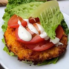 a close up of a plate of food with lettuce and tomatoes on it