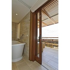 a bathroom with a large tub next to a sliding glass door