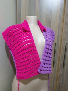 a pink and purple crocheted scarf on a mannequin