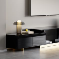 a modern black and gold sideboard in a living room with a large mirror on the wall