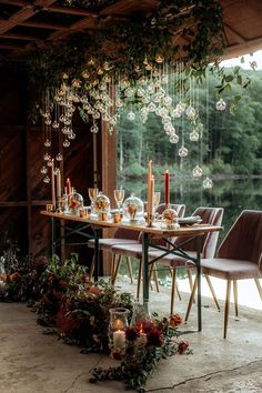 a dining table with candles and flowers on it