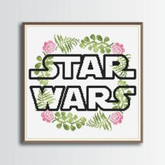 a cross stitch pattern with the words star wars in black and pink, surrounded by flowers