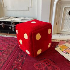 a red dice sitting on top of a rug