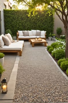 an outdoor living area with white couches and graveled path leading to the front door