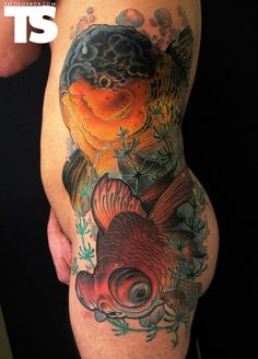 a man with a tattoo on his stomach has a fish and flowers in it's back