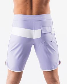 HIGHLIGHTS.. Unlined boardshort. 9” inseam Reflective branding at leg opening and back waistband Elastic waistband with adjustable self-tie drawcords Color-blocking panelling Water resistant fabric FIT SUGGESTION. This item runs true to Alphalete’s standard sizing.. Fit is based off of waist size in inches.. If you are between sizes, we recommend sizing up for a relaxed fit.. Eric is 6’2”/188cm, wearing a size 32. MATERIALS AND WASHING DIRECTIONS. 67% Nylon, 23% spandex. Due to the high saturati White Surfing Swim Trunks, Fitted White Swim Trunks For Surfing, White Fitted Swim Trunks For Surfing, Fitted Swim Trunks With Pockets For Sports, Summer Training Bottoms With Pockets, Sporty Fitted Shorts With Tie-side Bottom, Nylon Shorts For Water Sports, Sporty Swimwear With Elastic Waistband For Surfing, White Summer Bottoms With Elastic Side Panels