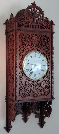 an ornate wooden clock hanging on the wall