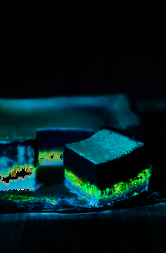 two pieces of cake sitting on top of a blue and green plate next to each other