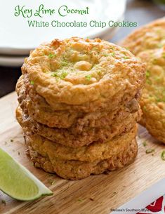 key lime coconut white chocolate chip cookies stacked on top of each other next to a lime wedge