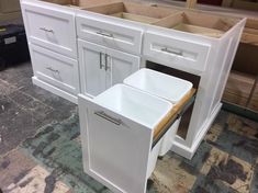 an unfinished kitchen with white cabinets and drawers