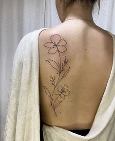 a woman with a flower tattoo on her back