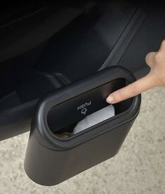 a person is pressing the button on a car door handle