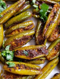 grilled green beans with cilantro and parsley on a white platter