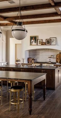 the kitchen is clean and ready to be used for cooking or dining, with pictures on the wall