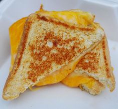 a grilled cheese sandwich on a white plate