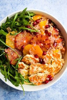 a white bowl filled with food on top of a blue table