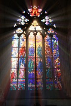 the sun shines through a stained glass window