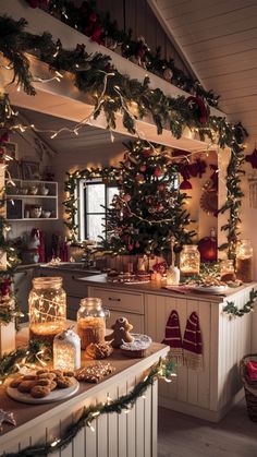 a kitchen decorated for christmas with lights and cookies on the counter top, surrounded by greenery