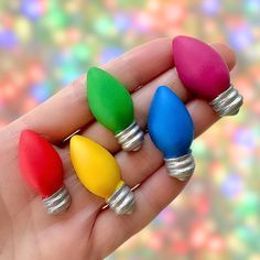 three small colored lights are held in someone's hand