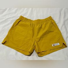 The Women's Journey Tech Short Color: Vintage Mustard Nylon / Spandex Blend Elastic Stretch Waistband 3.5" Inseam Standard Fit 2 Hand Pockets Concealed Rear Zip Pocket 4 Way Stretch Quick Dry Tech Lightweight & Soft Stretch Feel No Inner Liner A Do It All Short, Made For Any Adventure. The Flexibility, Soft Feel, Quick Dry Tech, And Functionality Of These Shorts Will Make Them Your New Favorite. New Condition, Never Worn! Sporty Elastic Nylon Shorts, Casual Elastic Nylon Shorts, Yellow Nylon Sports Shorts, Yellow Nylon Short Bottoms, Elastic Sports Shorts For Summer, Elastic Nylon Shorts, Yellow Nylon Shorts For Summer, Aqua Shorts, Pacsun Shorts