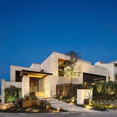 an exterior view of a modern house at night