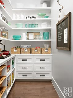 an organized pantry with white cabinets and drawers