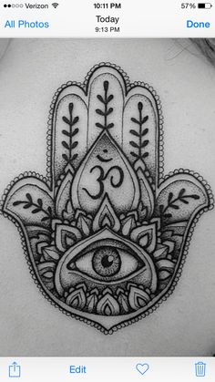 a hamsa tattoo with an eye on it