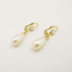 "Bridal Pearl Earrings, Pearl Stud Earrings, Bridal Earrings, Bridal tear drop pearl earrings, Wedding accessories, Gold and pearl jewelry for the bride. The bridal pearl earrings, features Swarovski teardrop pearl with a stud gold coated earring, and tiny Swarovski pearl inlay. The studs can be replaced with a hook hanging earring also with Swarovski pearl inlay. (Appear in the fourth photo). The design is very delicate, made with fine 24K gold plated earrings, NICKEL FREE. You can choose your Gold And Pearl Jewelry, Pearl Drop Earrings Wedding, Bridesmaid Pearl Necklace, Wedding Earrings Pearl, Bridal Pearl Earrings, Teardrop Pearl Earrings, Drop Pearl Earrings, Hanging Earring, Bridesmaid Pearls