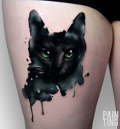 a black cat with green eyes is painted on the side of a woman's thigh