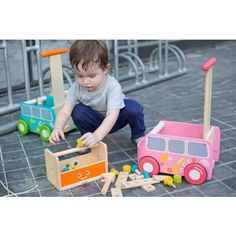 a small child playing with toys on the ground