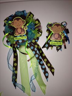 two green and blue ribbons with monkeys on them