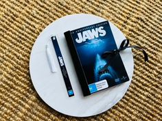 Jaws Journal Notebook | Upcycled DVD cover Transport yourself back to the magic of your favourite movies with an upcycled handmade DVD Journal. This unique journal features 80 blank sides plus 8 nostalgic images, ready to be filled with words, drawings, pictures and memories. The durable, hand-sewn signatures (2) are bound together with sturdy wax thread and protected by laminated DVD covers. This cover also has a new black spine and a ribbon to secure your journal together. AND...who can resist Words Drawings, Dvd Cover, Nostalgic Images, Unique Journals, Dvd Covers, Handmade Book, Blank Book, Book Journal, Journal Notebook