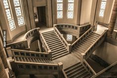 the inside of a building with stairs and windows