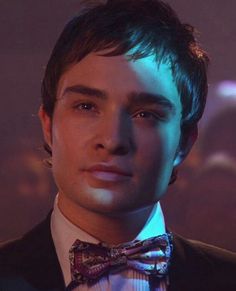 a young man wearing a suit and bow tie