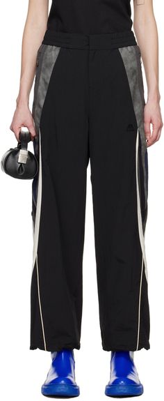 Wide-leg crinkled nylon taffeta and faux-leather track pants. · Paneled construction · Elasticized waistband · Two-pocket styling · Zip-fly · Logo embroidered at front · Bungee-style drawstring at cuffs · Piping at outseams · Full stretch mesh lining Supplier color: Noir Ader Error, Fly Logo, Sleepwear & Loungewear, Lounge Pants, Logo Embroidered, Active Wear For Women, Track Pants, Piping, Apparel Accessories