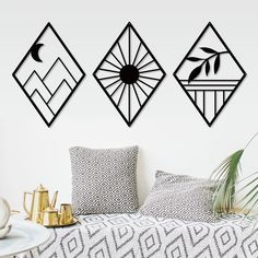 three decorative wall art pieces hanging above a bed