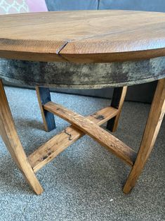 a wooden table sitting on top of a carpeted floor