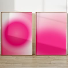 two pink and white abstract paintings on the wall in an empty room with hard wood flooring