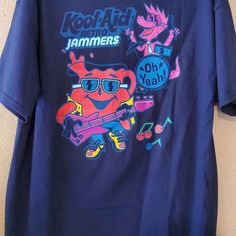 Kool-Aid Oh Yeah! Retro Jammers Men's Size X-Large Blue, 100% Cotton, Tee T-Shirt -New Without Tags. Casual Pre-shrunk Shirt For Fan Merchandise, Casual Pre-shrunk Shirt For Fans, Blue Fan Merchandise T-shirt For Summer, Blue Summer Fan Merchandise T-shirt, Casual Short Sleeve Fan Merchandise Top, Summer Cotton Shirt For Fan Apparel, Casual Summer Fan Merchandise Tops, Casual Short-sleeve Fan Merchandise Top, Casual Short Sleeve Tops For Fan Merchandise