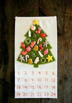 a christmas tree made out of paper on top of a wooden table next to a phone