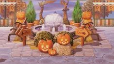 pumpkins sitting on benches in front of a fountain