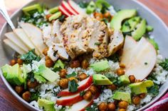 a bowl filled with rice, avocado, chickpeas and garbanzo