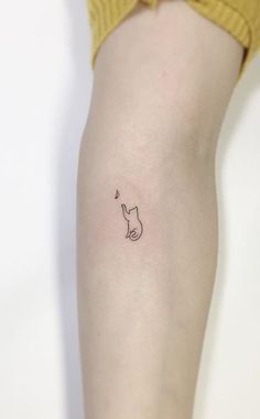 a small cat tattoo on the right thigh, with a tiny heart at the bottom