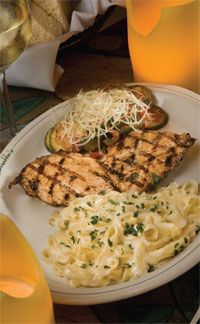 grilled chicken, macaroni and cheese on a white plate