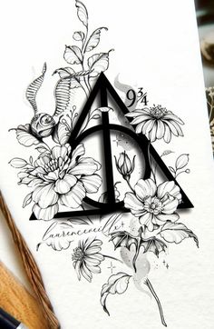 the letter d is surrounded by flowers and leaves, with an intricate design on it