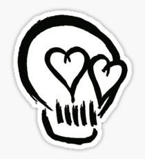 a black and white sticker with two hearts in the shape of a skull